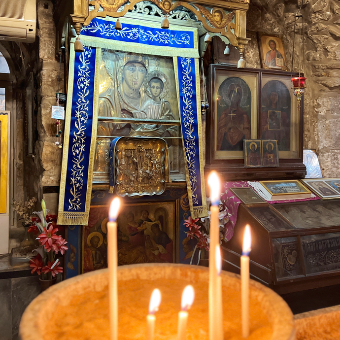 Candle in front of the miraculous icon of the Virgin