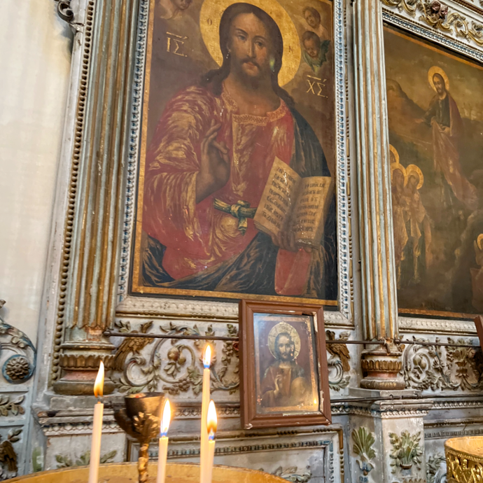 Candle before the icon of the Savior